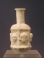 Sidonian mold blown opaque white glass flask with masks