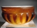 Early Roman amber glass ribbed bowl.