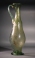 Roman light-green glass elongated jug with one handle, molded body with diagonal ribbing.