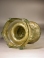 Roman olive green glass sprinkler with decorative handles around rim.