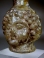 Roman light yellow glass Janus head tall flask.