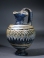 Eastern Mediterranean blue core form glass oinochoe with yellow and turquoise ornament.