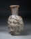 Early Roman deep amber glass Medusa Janus head flask.
