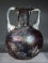 Roman purple glass aryballos with marbled blue glass handles