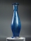 Early Roman blue glass unguentarium (cosmetic flask) with three pinched feet.
