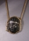 Early Roman bronze applique head of a woman with silver eyes and diadem, set in modern 18k gold setting.