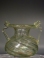 Roman clear glass jar with two handles.