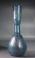 Roman light blue glass bottle with ribbed body and trailed neck.