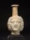 Roman molded opaque white glass Medusa Janus head flask.