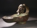 Roman bronze lamp with mask handle.