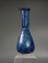 Early Roman cobalt blue glass unguentarium (cosmetic flask).