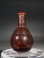 Early Roman amethyst purple glass unguentarium (cosmetic flask).