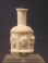 Sidonian mold blown opaque white glass flask with masks