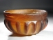 Early Roman amber glass ribbed bowl.