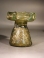 Roman olive green glass sprinkler with decorative handles around rim.
