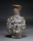 Early Roman deep amber glass Medusa Janus head flask.