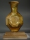 Sidonian golden yellow glass faceted flask with two handles.