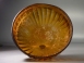 Early Roman golden-amber glass ribbed bowl.