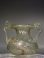 Roman clear glass jar with two handles.