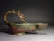 Roman bronze lamp with mask handle.
