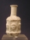 Sidonian mold blown opaque white glass flask with masks