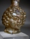 Roman light yellow glass Janus head tall flask.