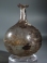 Roman light purple glass bottle with white glass spiral thread and trefoil rim.
