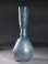 Roman light blue glass bottle with ribbed body and trailed neck.
