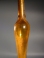 Roman golden yellow glass tall unguentarium.