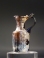 Roman amber glass juglet with trefoil mouth and ribbed body.