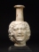 Roman molded opaque white glass Medusa Janus head flask.