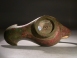 Roman bronze lamp with mask handle.