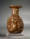 Roman yellowish green glass Janus head flask.