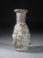 Early Roman deep amber glass Medusa Janus head flask.