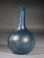 Early Roman blue glass unguentarium (cosmetic flask).