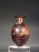 Sidonian purple glass flask with tendril scroll ornament.