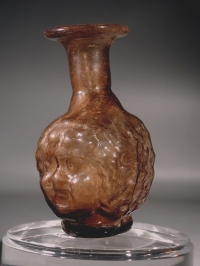 Roman light purple glass putto Janus head flask.