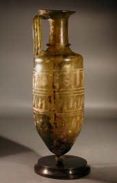 Roman olive green glass amphora with wheel-cut ornament and pointed-base.