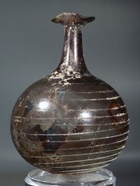 Roman light purple glass bottle with white glass spiral thread and trefoil rim.