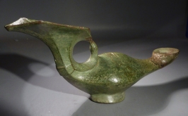 Byzantine bronze lamp with a cross and blossom handle.