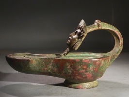 Roman bronze lamp with mask handle.