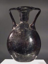 Late Roman dark amber - black glass lentoid flask.