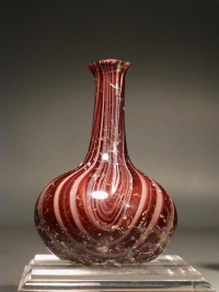 Early Roman red and white glass ribbon flask.