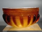 Early Roman amber glass ribbed bowl.
