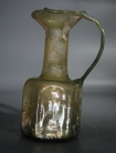 Early Christian light olive green hexagonal glass jug with three crosses.